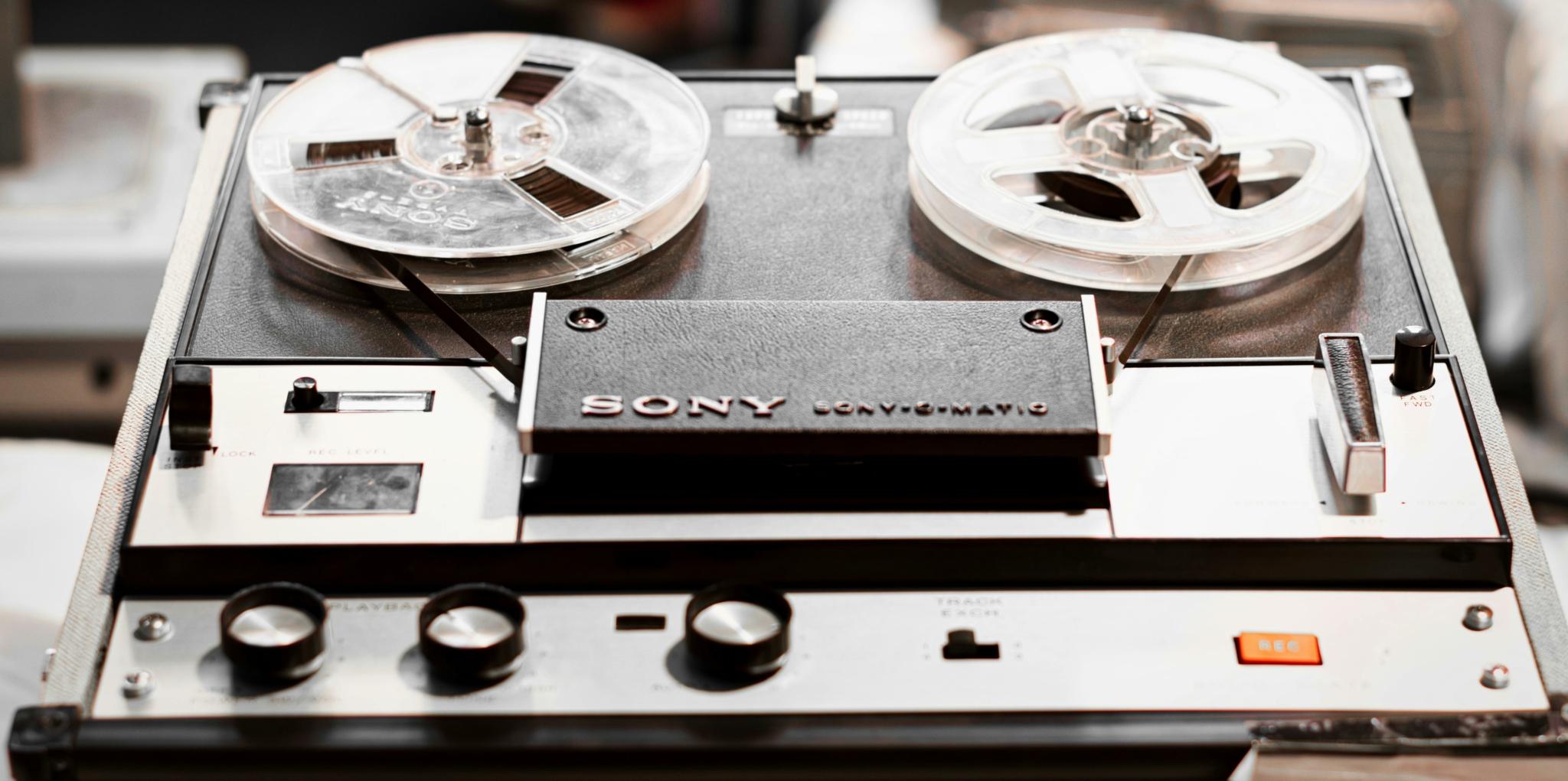 Sony reel-to-reel tape recorder with visible playback and recording controls.