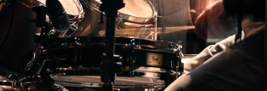 musician recording drums at the studio