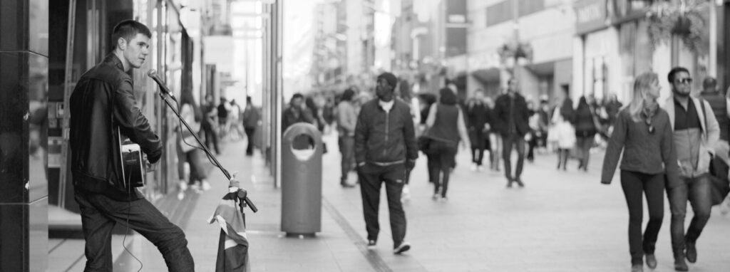 musician playing on the street, distributing his music