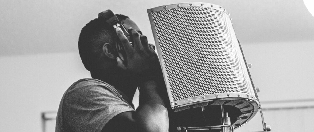 rapper singer recording rap vocals in studio