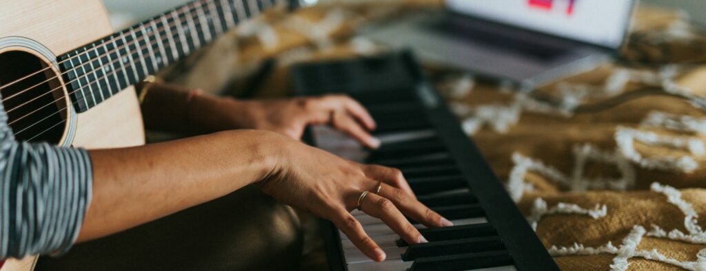 musician recording keys at home studio